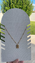 Collier doré visage